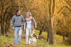 older-adults-walking-dog